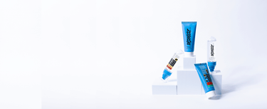 The best mens skincare essentials assembled next to each other on white blocks.
