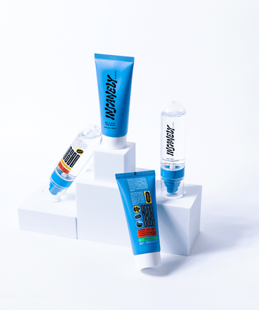 Men's essential skincare products displayed uniquely on a podium.