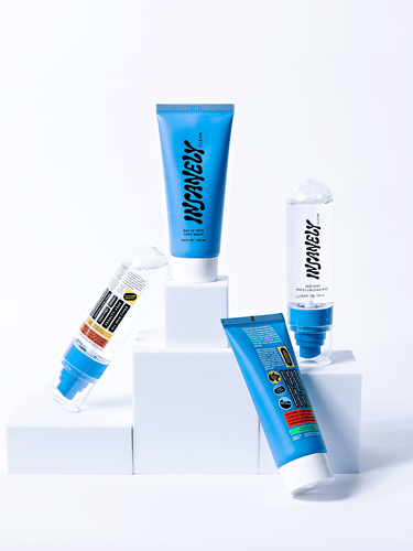 The best mens skincare essentials assembled next to each other on white blocks.